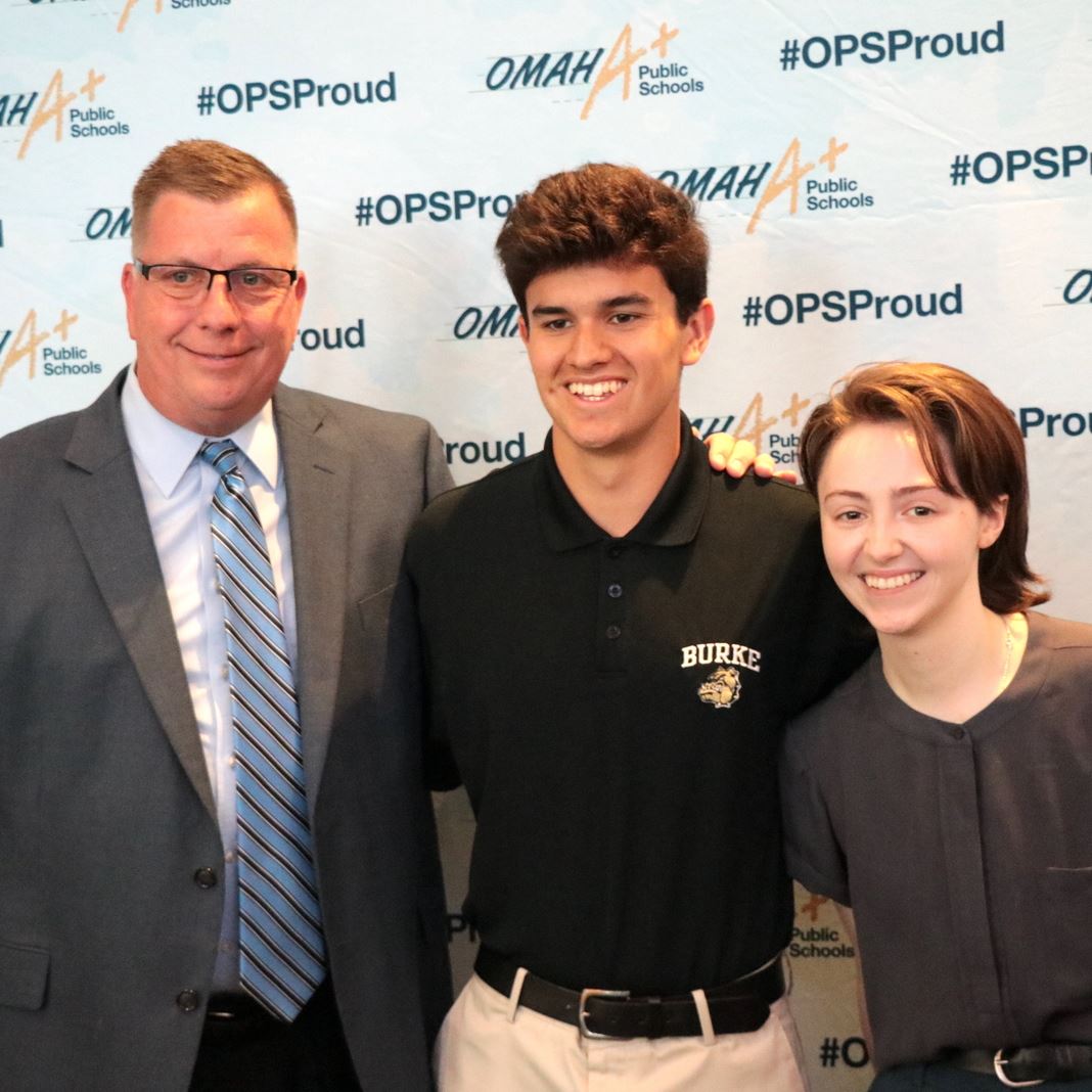  Burke principal and students in front of OPS Proud backdrop